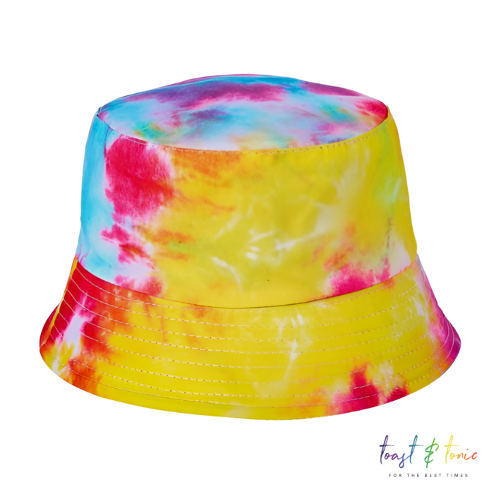 Tie dye bucket hat, hand dyed to create a unique pattern of yellow, pink and blue.  shop now at toast and tonic for bucket hats